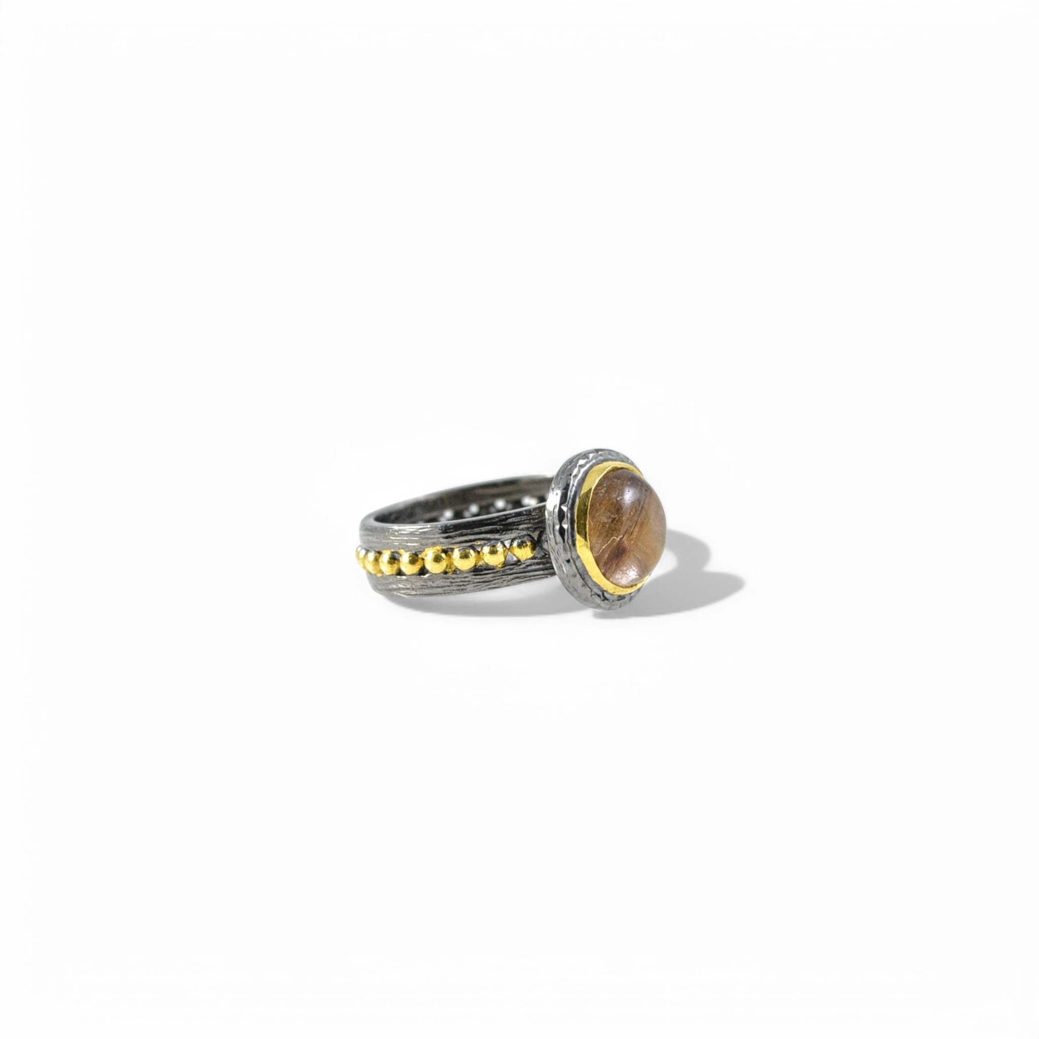 Handmade oxidised silver ring with brown rutilated quartz and gold bezel.